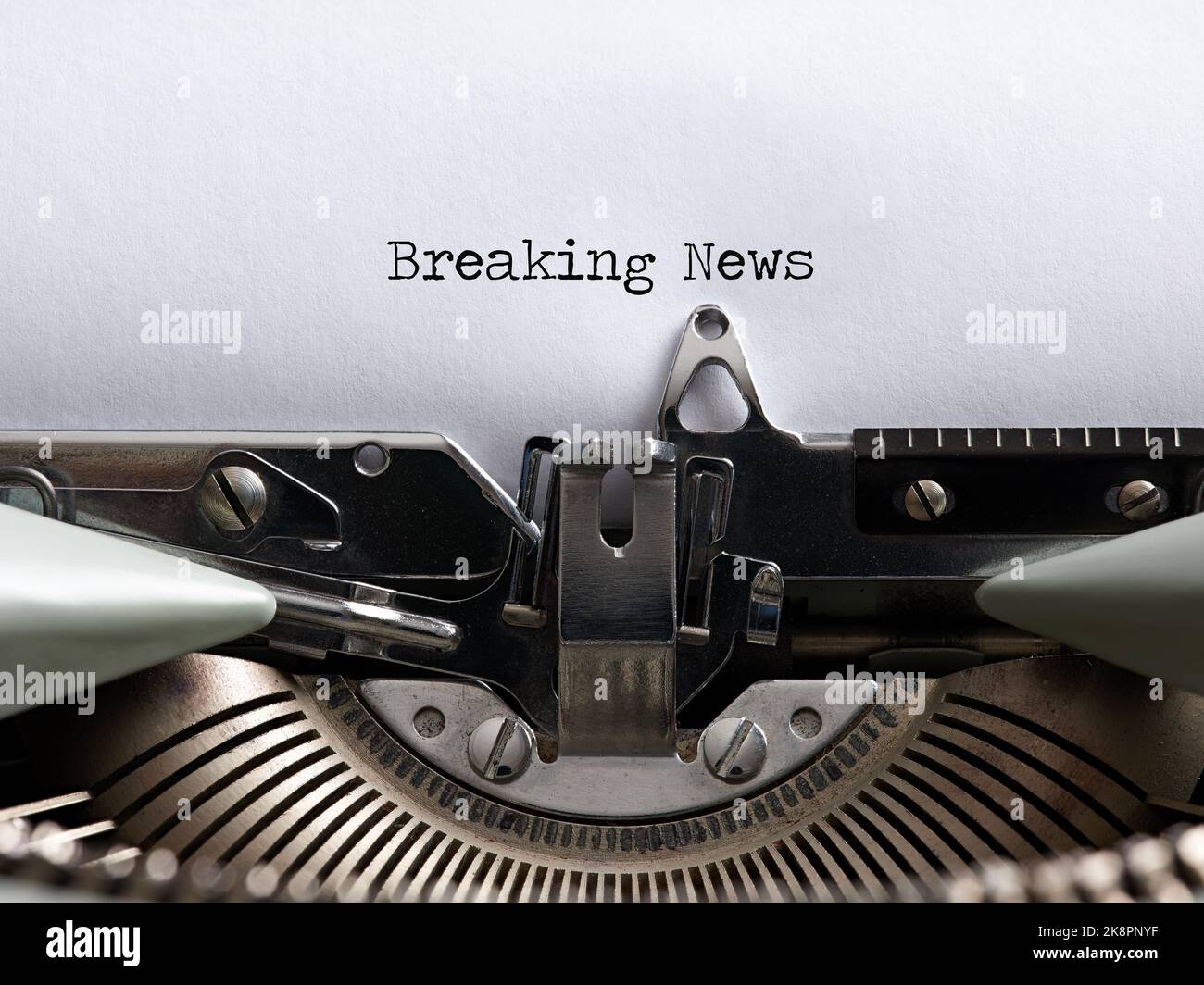 The word breaking news written with a vintage typewriter. Journalism, media information headline concept. Stock Photo