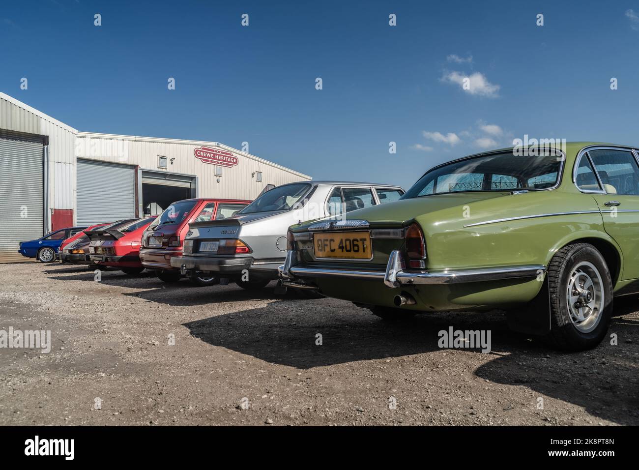 A row of old retro cars parked in front of Crewe Heritage Centre museum