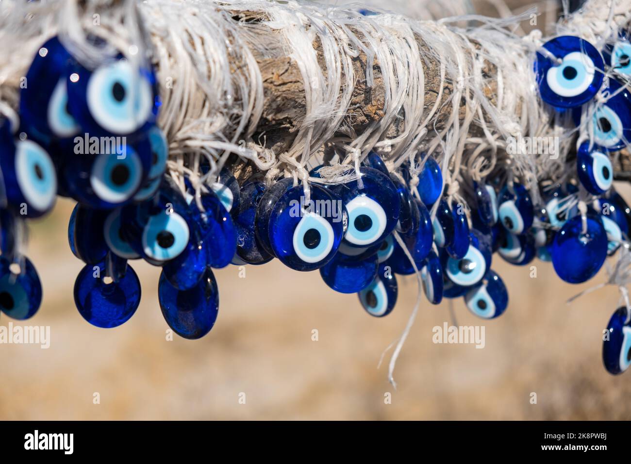 many traditional turkish Evil Eye Bead Amulets on the tree nazar boncuk from blue glass Stock Photo
