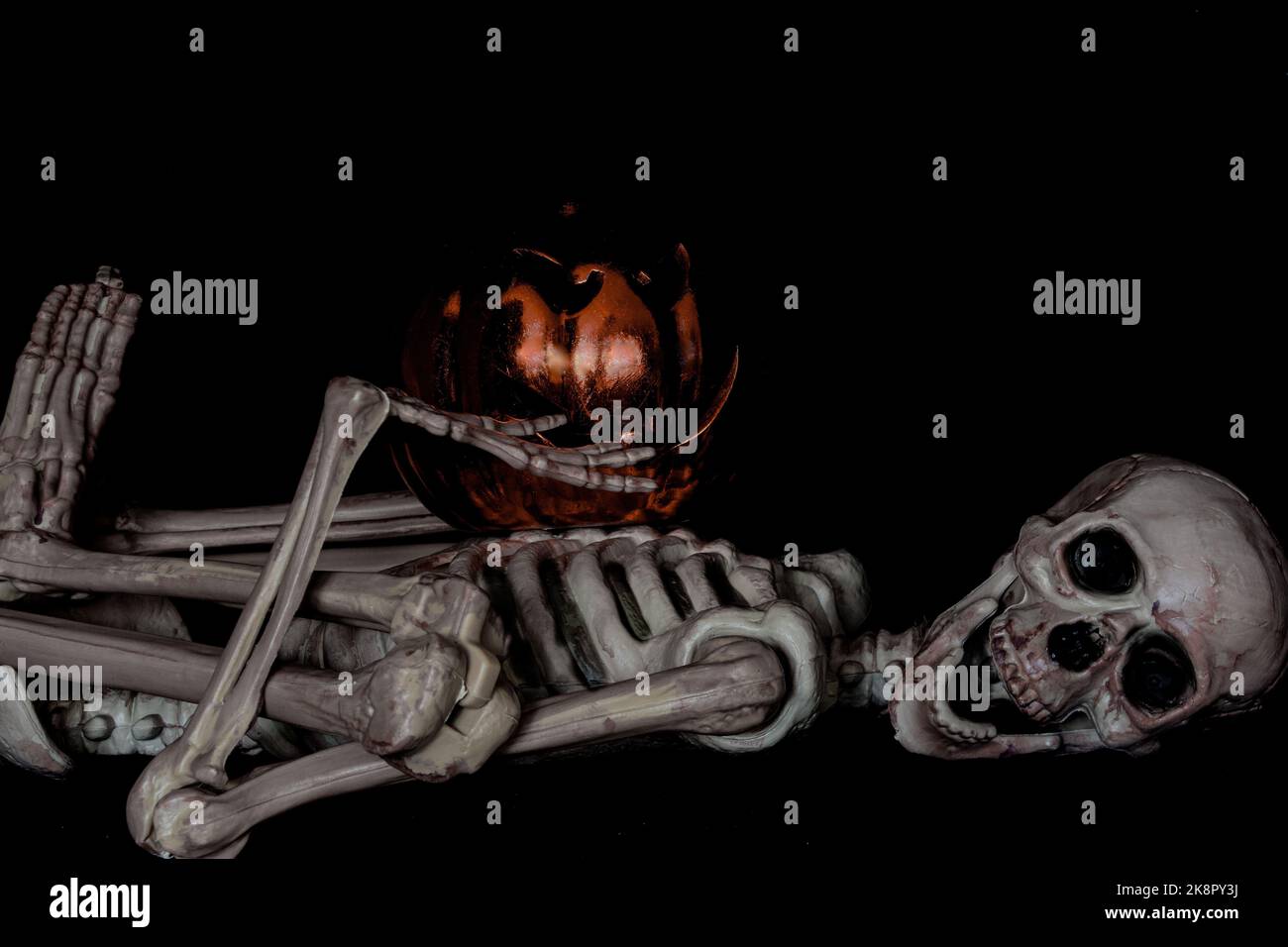 Halloween Skeleton  lying  down   pirate  with  pumpkin Stock Photo