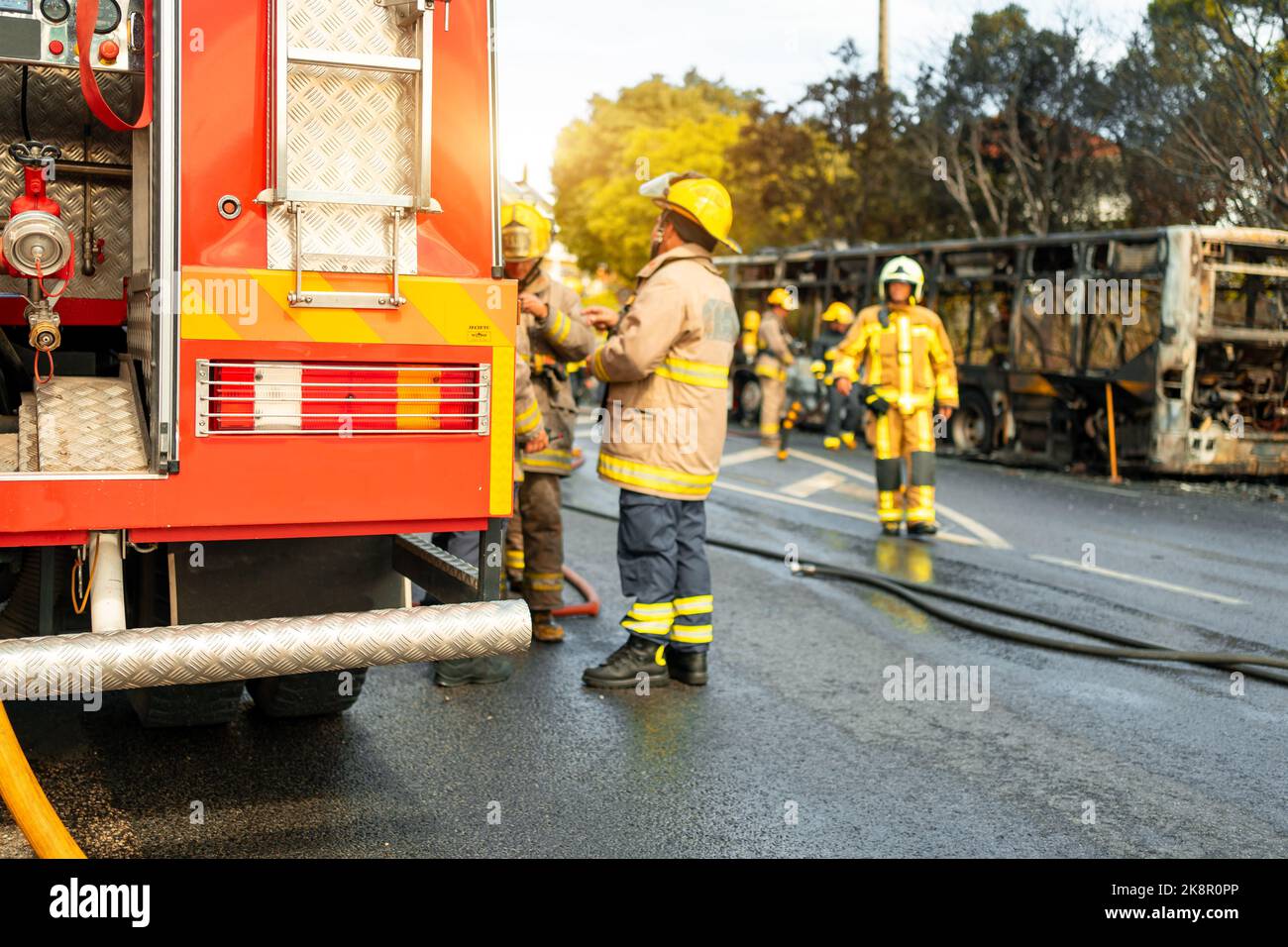 Rescue Team of Firefighters Arrive on the Car Crash fired passenger bus