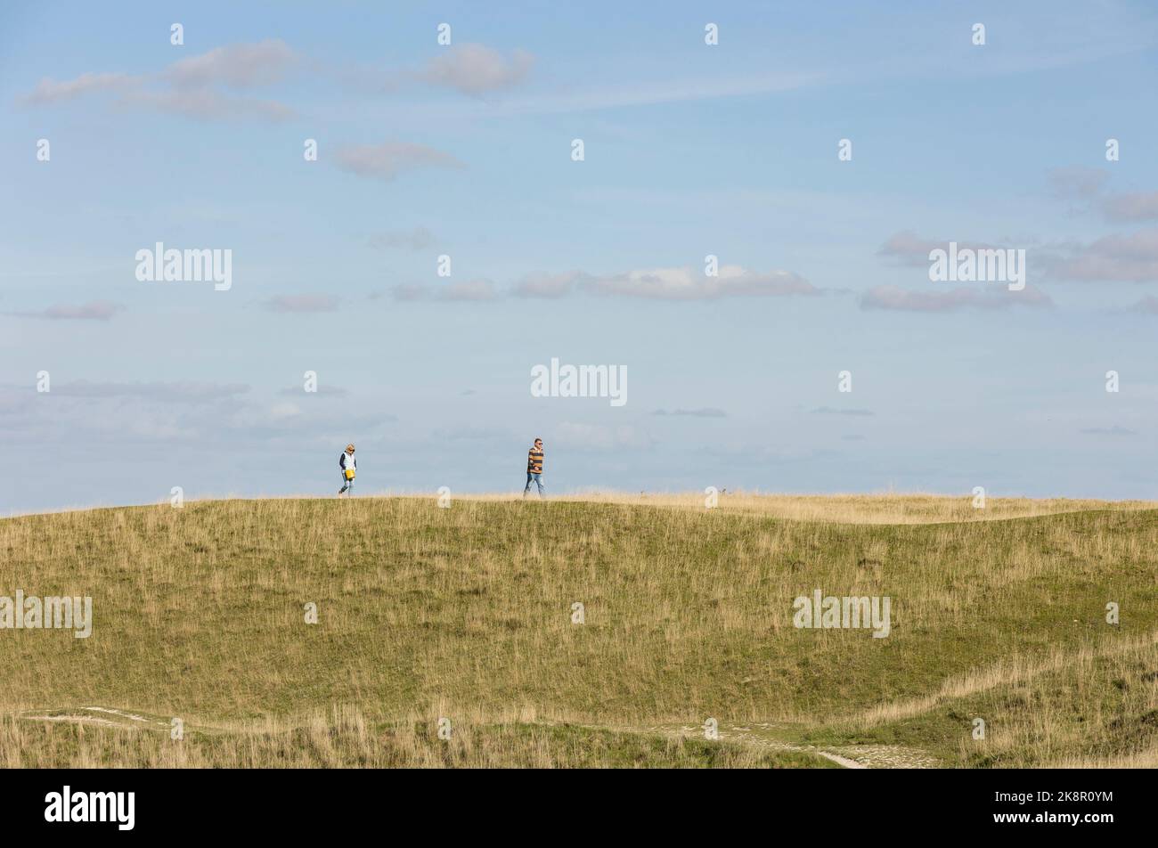 Salisbury Wiltshire, Uk, 10, October 2022 man and woman walking along a hilltop in the summer sun, solitude concept Stock Photo