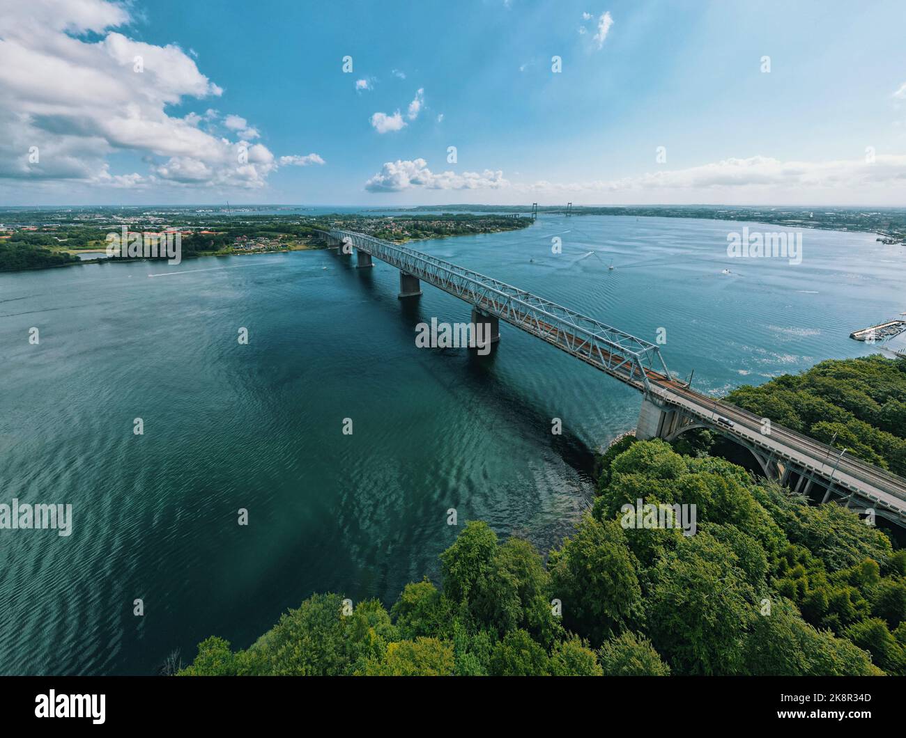 An aerial view of the Little Belt bridge connecting the coasts under the blue sky in Danmark Stock Photo