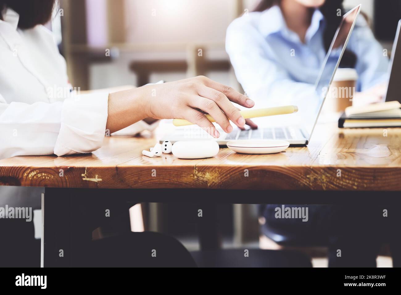 Female Charging Smartphone Using Wireless fast Charging pad at work