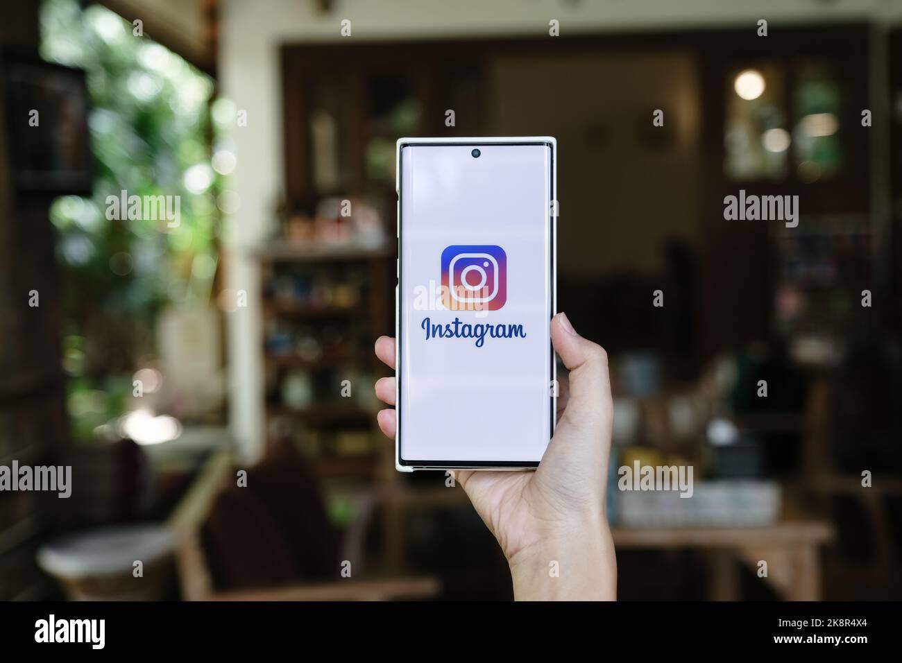 CHIANGMAI, THAILAND - July 09, 2021: A woman holding smartphone with Instagram application on the screen. Instagram is a photo sharing app for Stock Photo