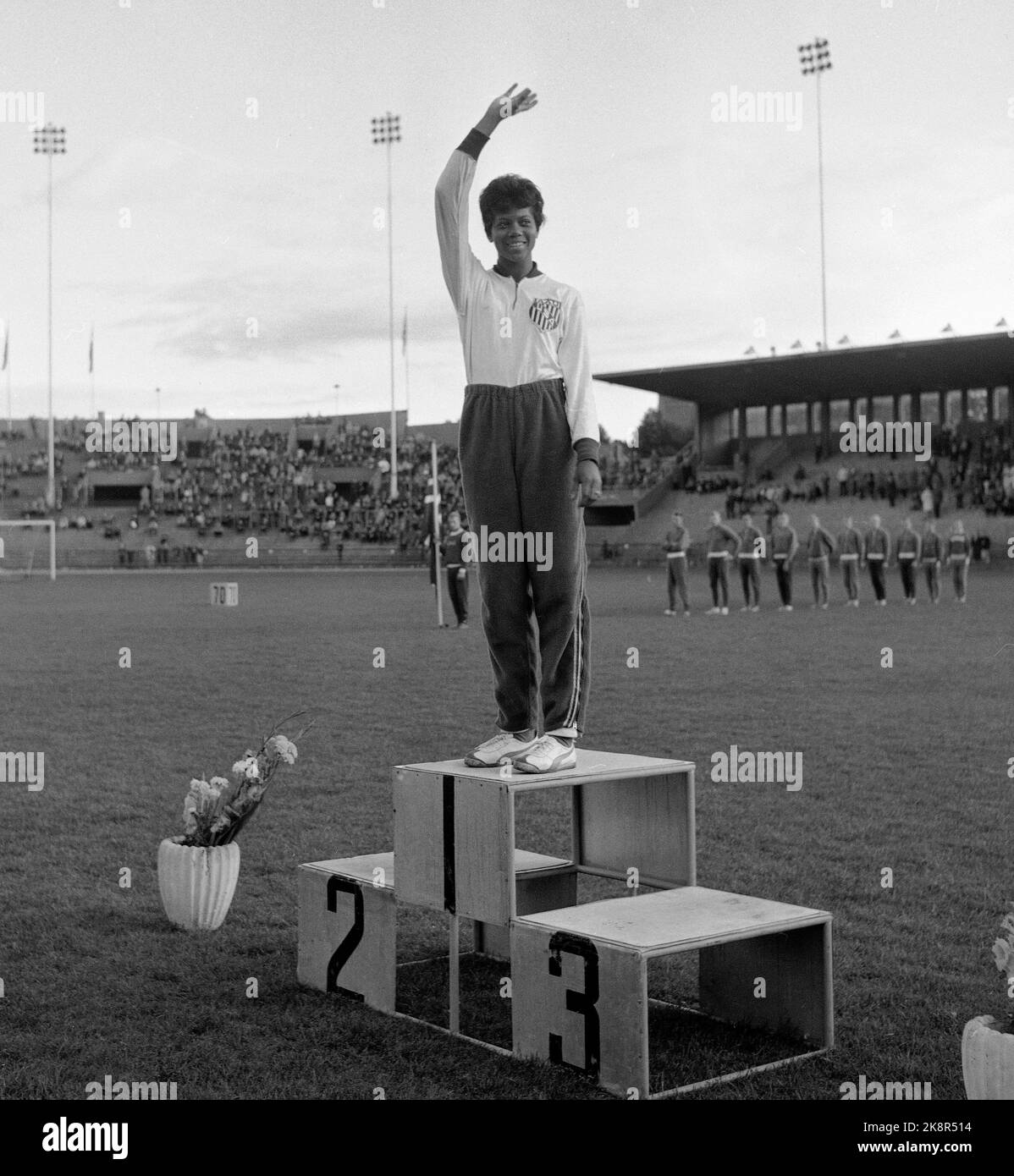 Oslo 19620828 American athletics star Wilma Rudolph, who took three gold medals during Olympic Games in Rome 1960, visits Norway. Here at the victory podium during an athletics event at Bislett. Photo: NTB / NTB Stock Photo