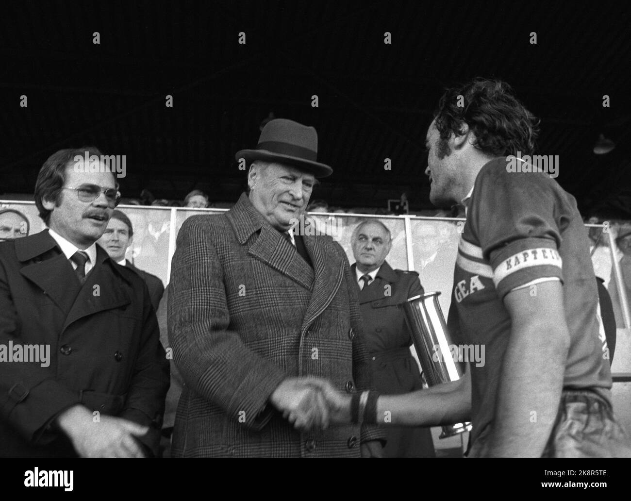 Oslo 19821024 Football, cup final Fire - Molde 3-2, Ullevaal Stadium. Fire won the cup final, and team captain Neil Macleod welcomes the King's Cup by King Olav. Football president Eldar Hansen t.v. NTB archive photo Svein Hammerstad / NTB Stock Photo