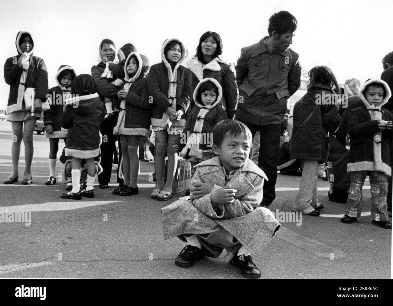 Oslo 19780413. Vietnamese refugees to Norway. A large group of Vietnamese refugees came to Norway and Fornebu by plane after a long journey. Some travel to Bergen, but most stay in Oslo. Here is a little boy in front of many girls, all dressed in the same duffel coats. Photo: NTB archive/ NTB Stock Photo