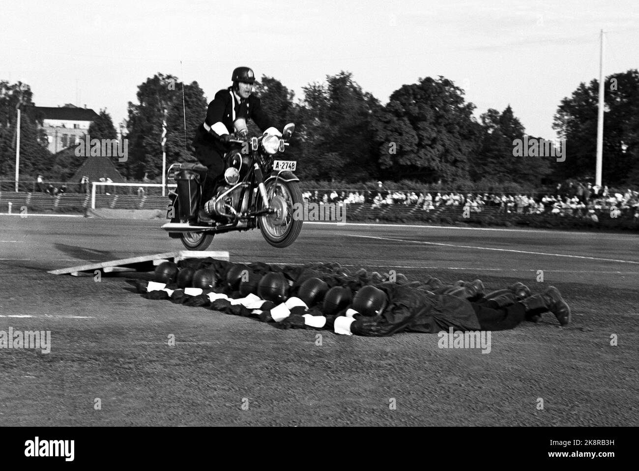 Oslo 19630607. Police Day at Frogner Stadium. Here motorcycle shows. Jumps on motorcycle over reclining officers. Photo: Erik Thorberg / NTB / NTB Stock Photo