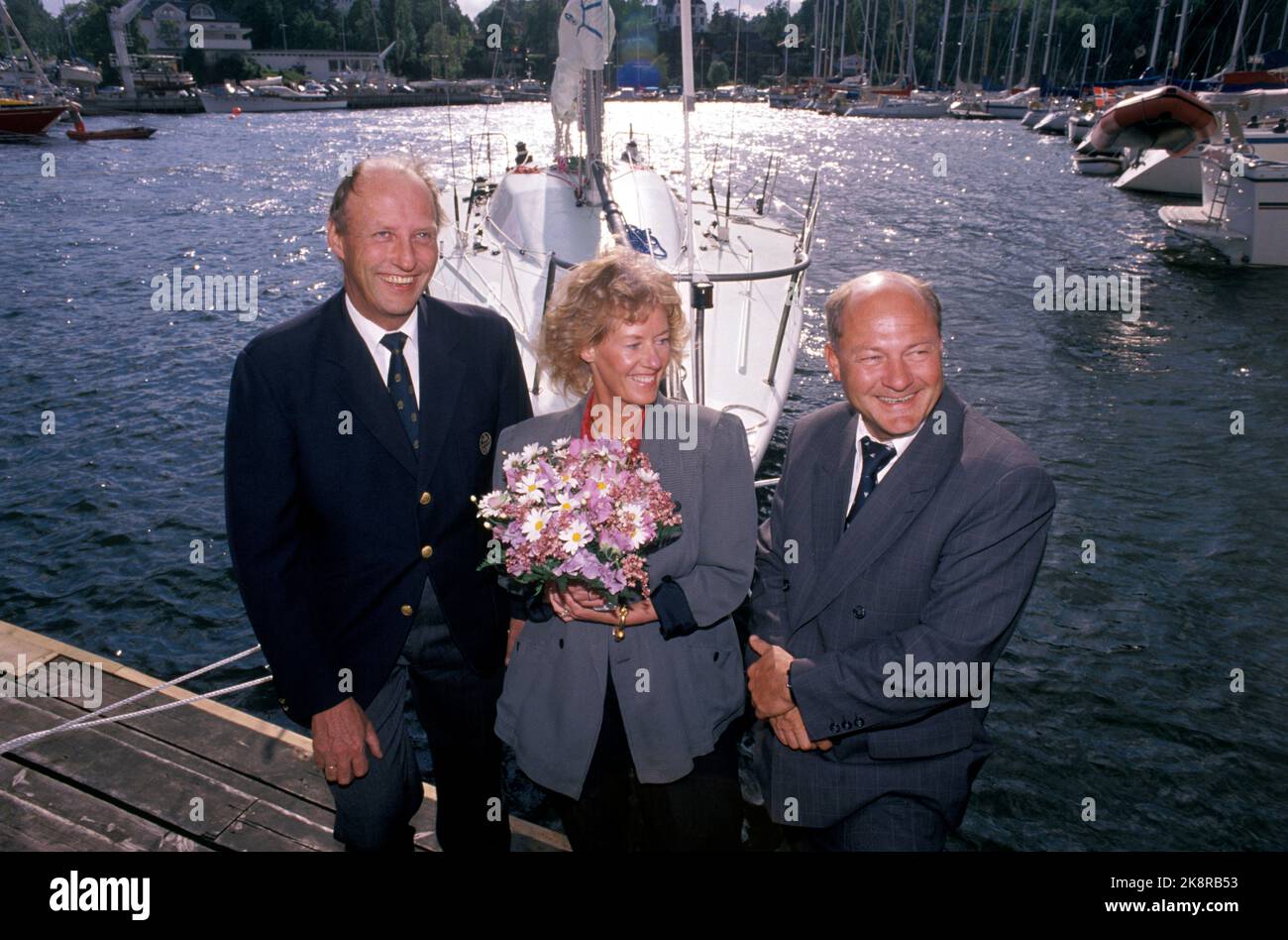 Oslo 19890608 The sailboat 'Fram XI' is baptized by Else Sundt. On Thursday, Crown Prince Harald's new Entonner 'Fram XI' was baptized at the Queen in Oslo. It was Else Sundt, shipowner Petter C.G. Healthy Wife, who became the godmother of the boat after she crushed the champagne bottle against the ship's side. It was no coincidence that it was precisely her who got the honor. It's Petter C.G. Sundt who has funded the new regatta machine. Only the boat has cost NOK 2.1 million. From V: Crown Prince Harald, Else Sundt and Petter Sundt. Photo: Olav Olsen / NTB Stock Photo