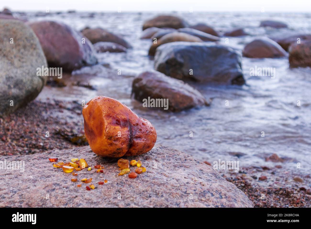 Huge bright yellow amber with sand, Baltic sea and rocks Stock Photo ...