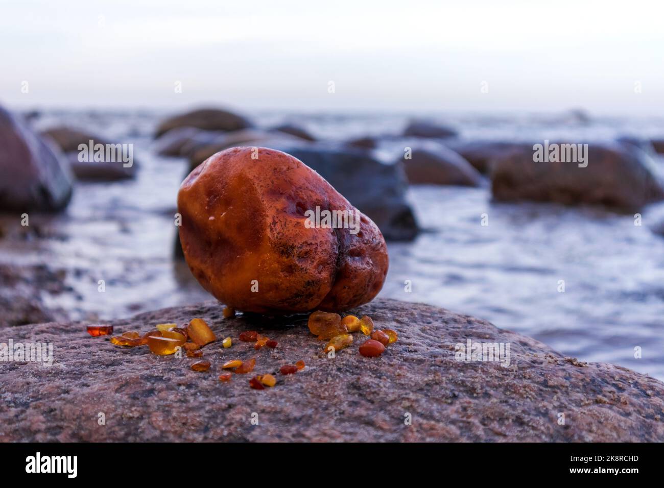 Huge bright yellow amber with sand, Baltic sea and rocks Stock Photo ...