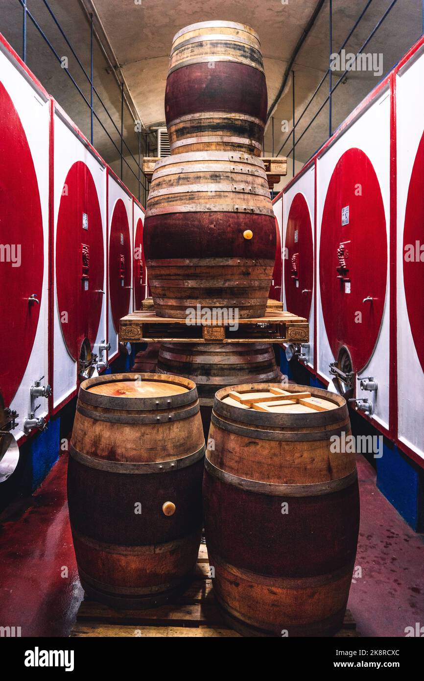 Wine Barrels stacked in a colorful Italian Winery Stock Photo Alamy