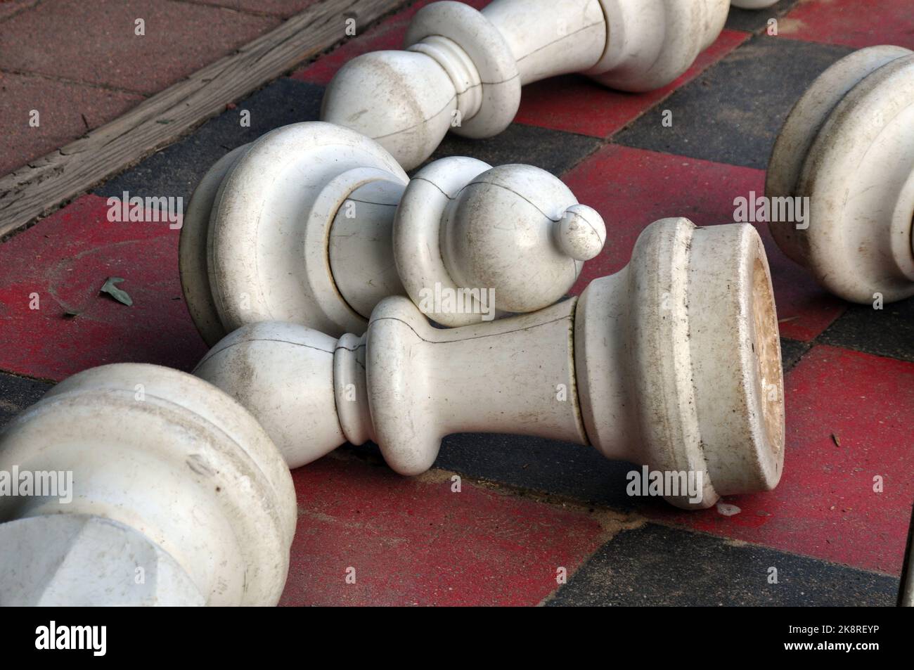 Fallen White Pawns on a Large Outdoor Chess Board Stock Photo