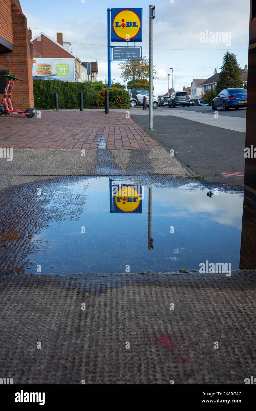 Lidl store sign reflecting in a puddle of water (Oct22) Stock Photo