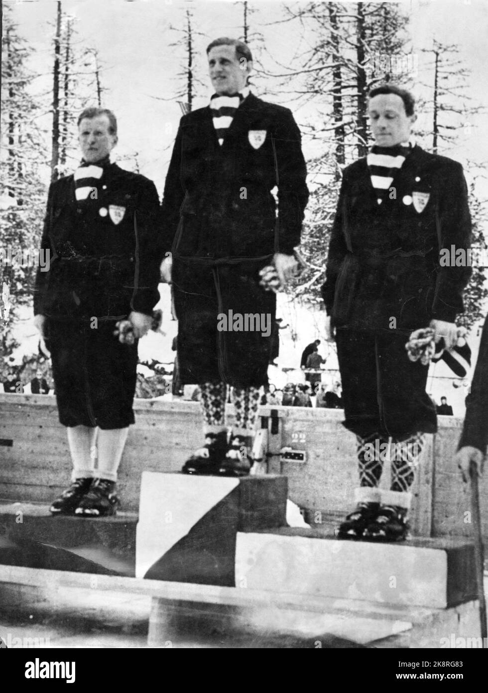 St. Moritz 1948: Olympic Winter Games in St. Moritz 1948. Norway takes all the medals in the normal hill. Here the three on the victory podium,- From V: Birger Ruud (Silver) Petter Hugstedt (gold) and Thorleif Schjelderup (bronze) Photo: NTB / NTB archive. Stock Photo