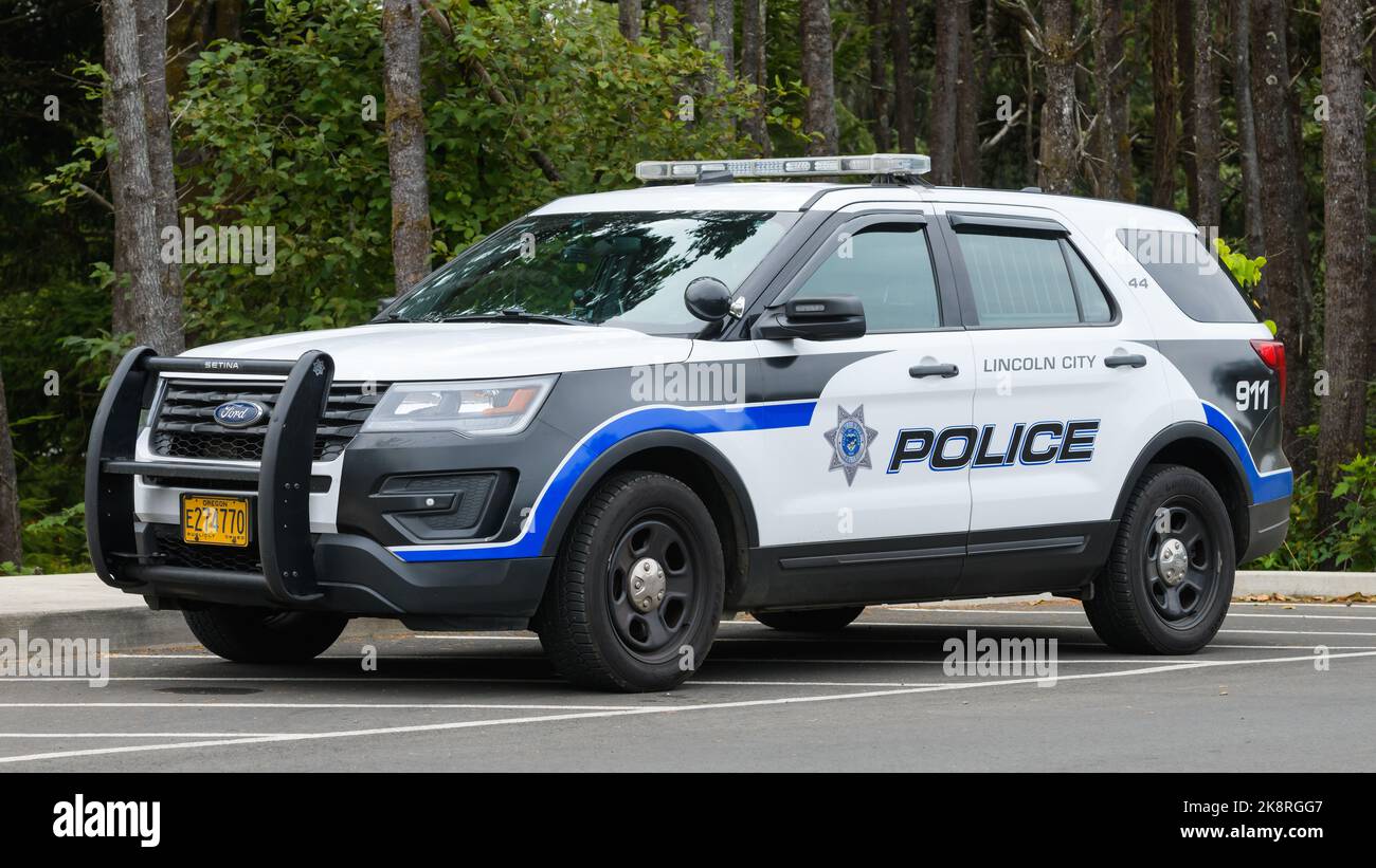 Lincoln City, OR, USA - September 15, 2022; Lincoln City police car parked against woodland Stock Photo