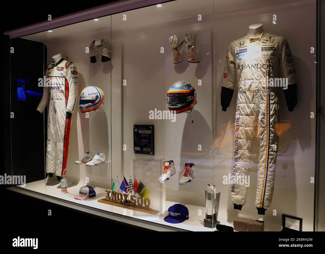 Display of Fernando Alonso's trophies crash helmets gloves boots nomex racing clothes at the Museum and Circuit Oviedo Asturias Spain Stock Photo