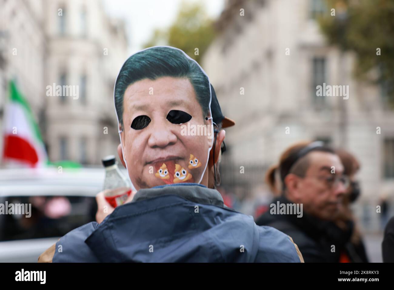 London, UK. 23rd Oct, 2022. Protester wears a mask with Xi Jinping's face on it during the demonstration. Hundreds of people marched from Downing Street via Chinatown to the Chinese Embassy in London, to protest against the assault incident in which a Hong Kong protester Bob Chan, who was seen being pulled into the grounds of a Chinese consulate in Manchester and beaten by staff on October 17, 2022. Credit: SOPA Images Limited/Alamy Live News Stock Photo