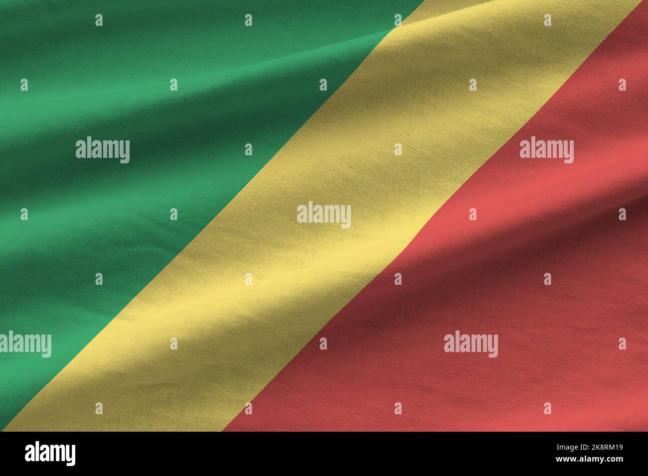 Congo flag with big folds waving close up under the studio light indoors. The official symbols and colors in fabric banner Stock Photo