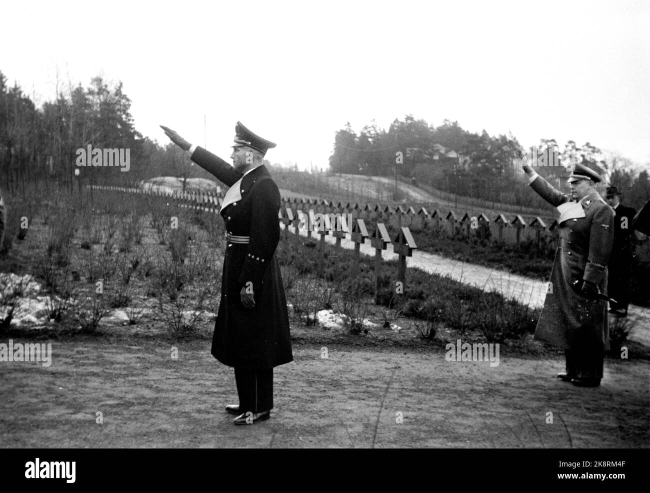Oslo 1942-12-12 The German Gesandt in Denmark, Best (Karl Rudolf Werner Best) Crossing the Cemetery of German soldiers at Ekeberg The Germans used the cemetery at Ekeberg throughout the war. Many German soldiers were buried here, including the dead from Blücher. Nazi greeting. Photo: Aage Kihle / NTB *** Photo not image processed ***** Stock Photo