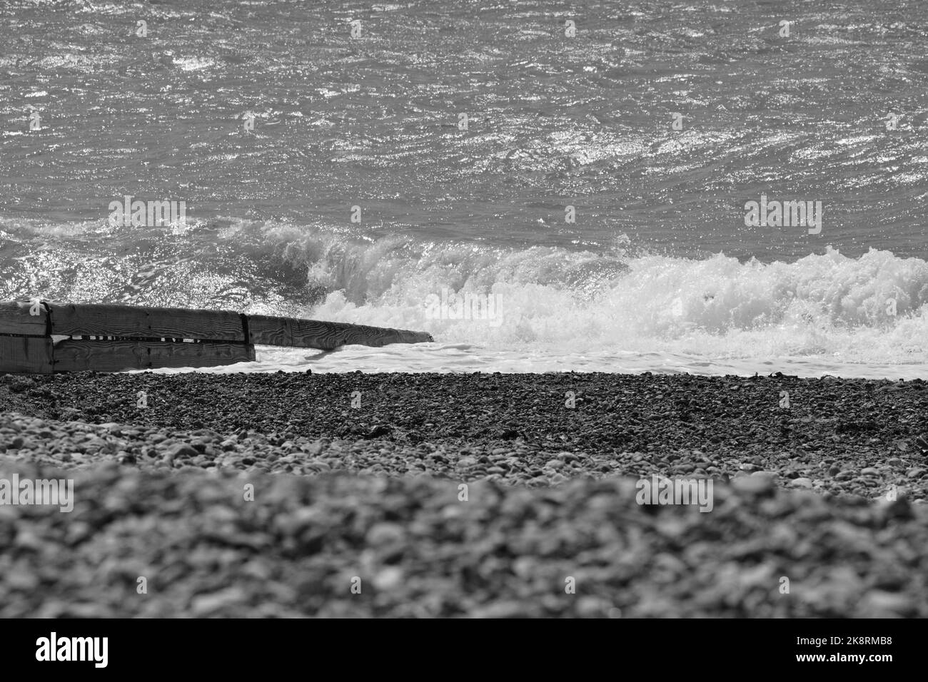 A black and white of sea wave crash into the rocks at the beach Stock ...