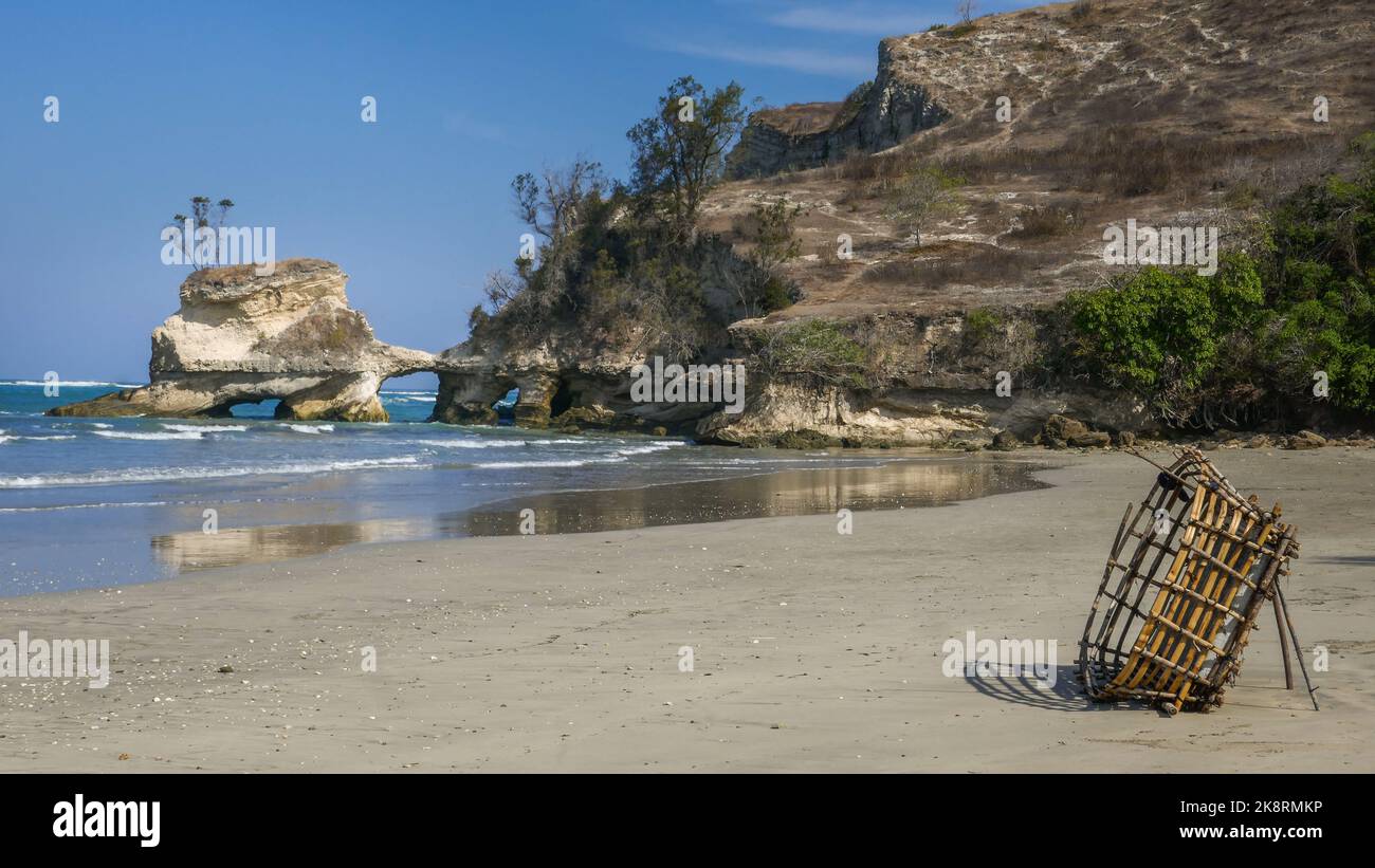 Landscape view of Watuparunu beach with spectacular rock formation and basket for harvesting algae, East Sumba island, East Nusa Tenggara, Indonesia Stock Photo