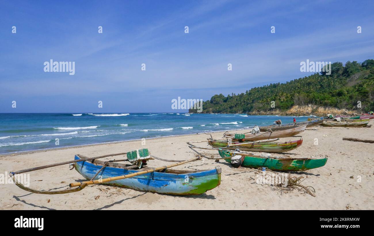 Scenic seascape view of Wanokaka beach with colorful outrigger fishing boats, Lamboya, Sumba island, East Nusa Tenggara, Indonesia Stock Photo