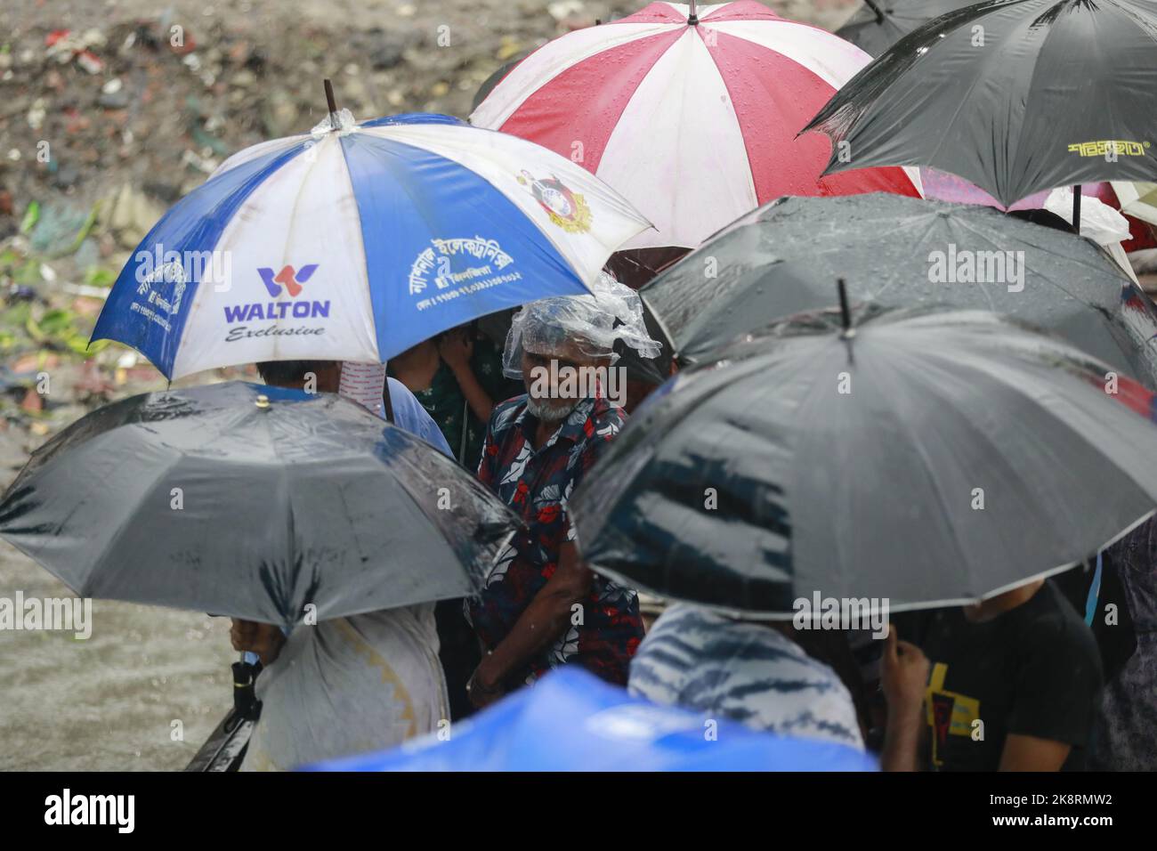 Dhaka, Bangladesh. 24th Oct, 2022. Bangladeshi passengers cross the