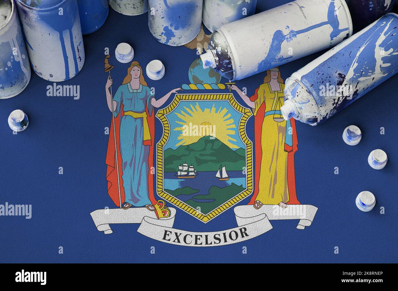 New York US state flag and few used aerosol spray cans for graffiti