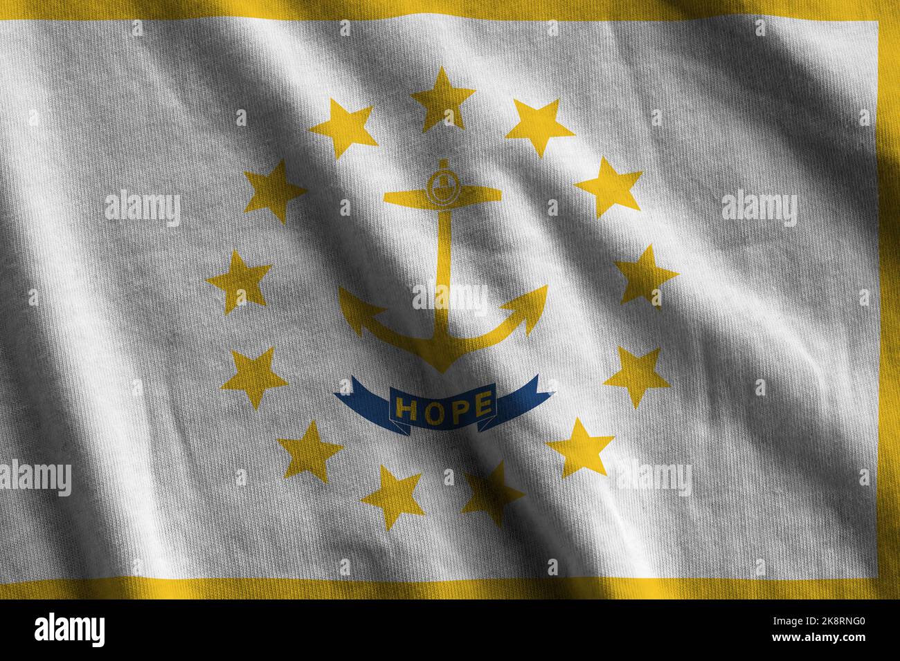 Rhode Island US state flag with big folds waving close up under the studio light indoors. The official symbols and colors in fabric banner Stock Photo