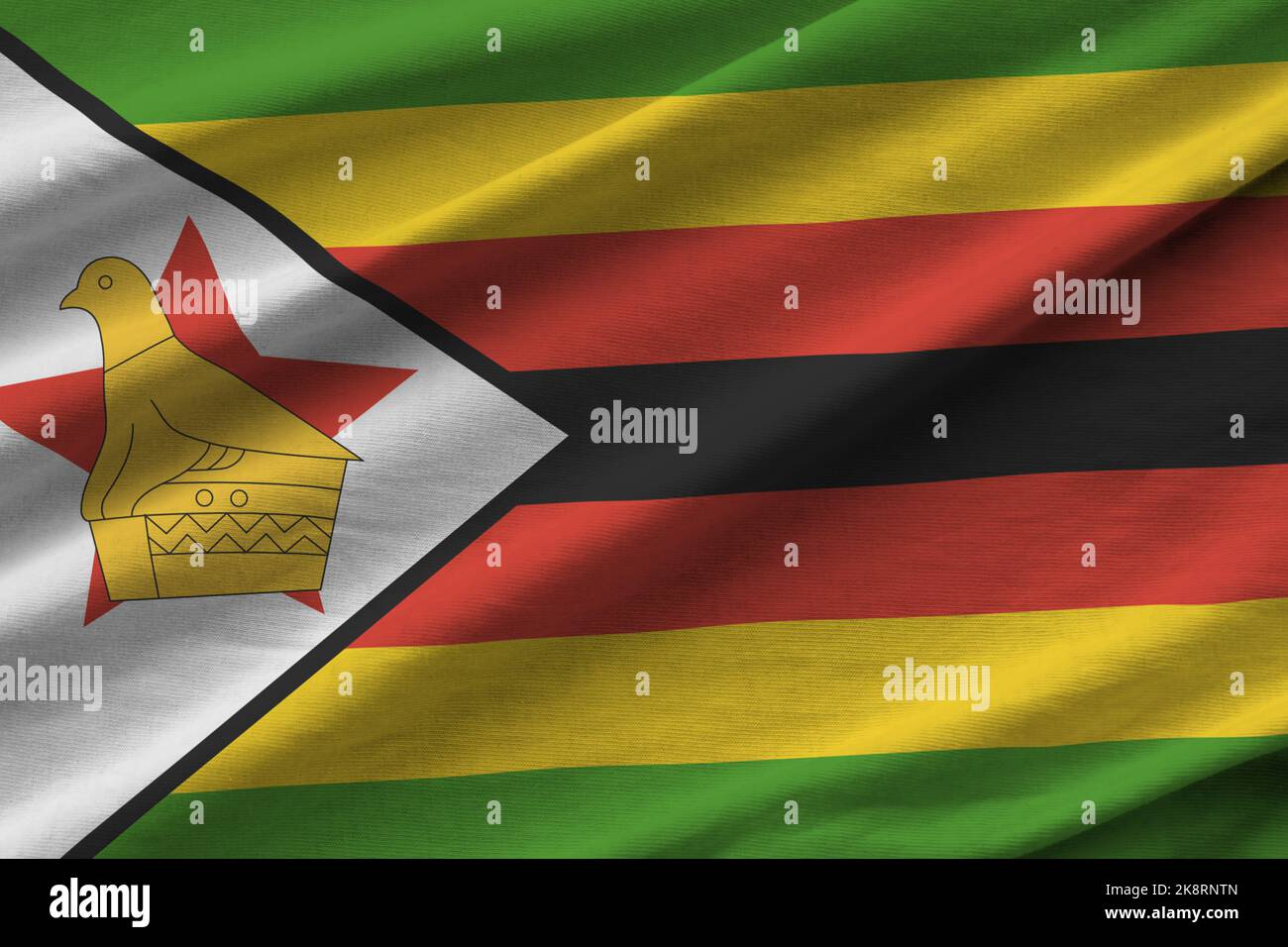 Zimbabwe Flag Reverse Zimbabwe flag with big folds waving close up under the studio light ...