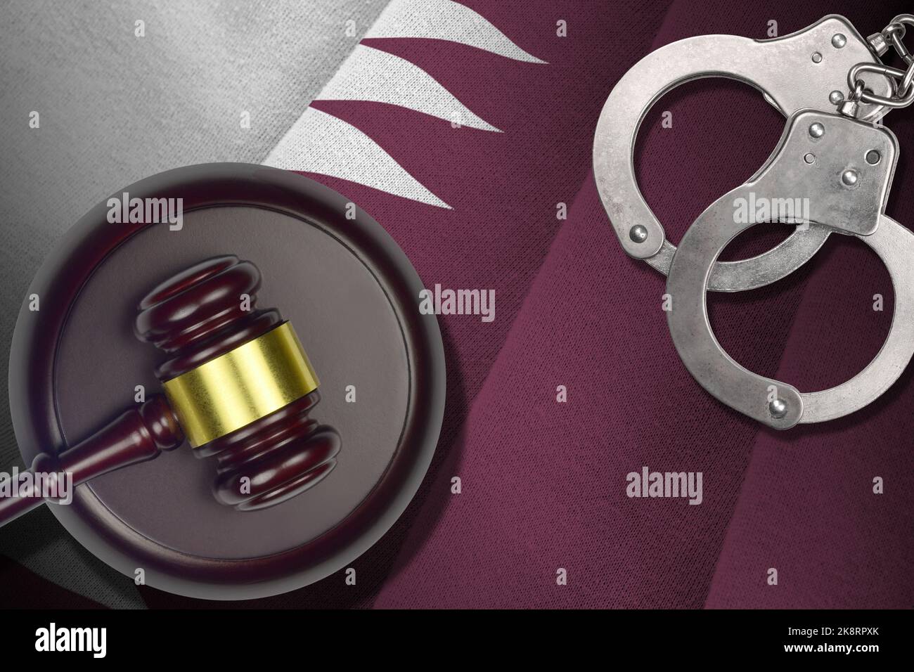 Qatar flag with judge mallet and handcuffs in dark room. Concept of