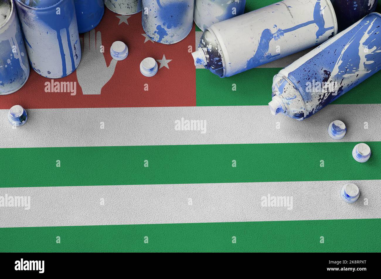 Abkhazia flag and few used aerosol spray cans for graffiti painting