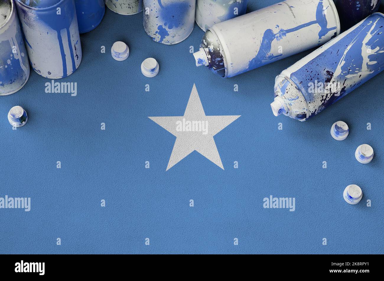 Somalia flag and few used aerosol spray cans for graffiti painting. Street art culture concept, vandalism problems Stock Photo