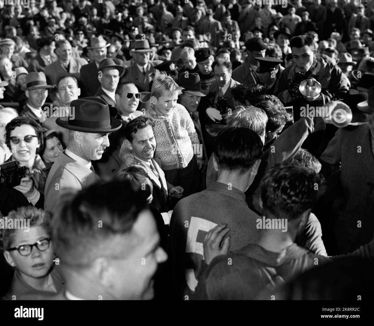 Oslo, 19561021. The cup final, Ullevaal Stadium. Larvik Turn - Skeid 1-2. Here the audience flocks around Skeid's players. Children, women and men. Photo: Jan Stage / NTB / NTB Stock Photo