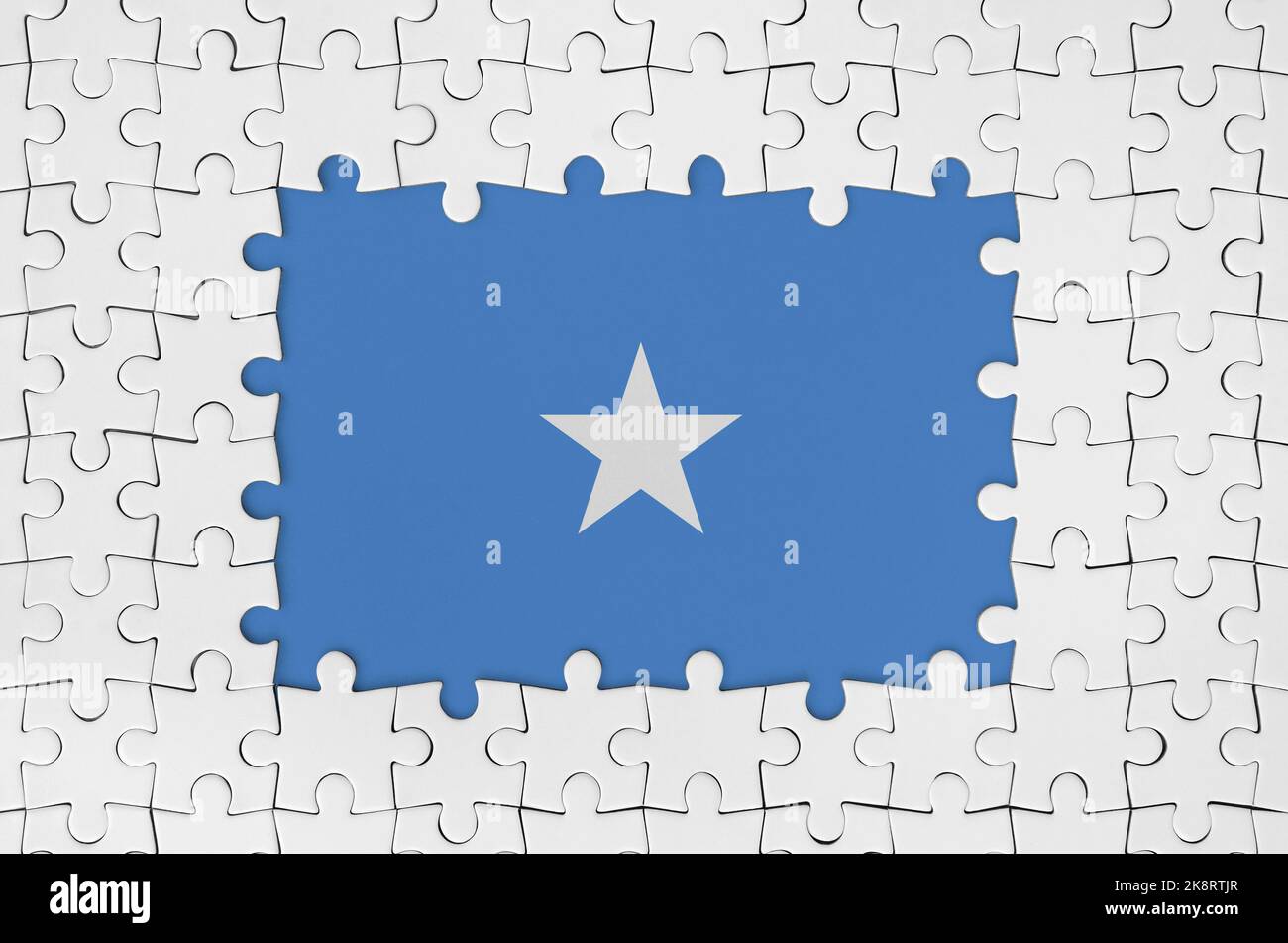 Somalia flag in frame of white puzzle pieces with missing central parts Stock Photo