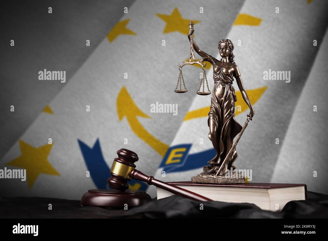Rhode Island US state flag with statue of lady justice, constitution and judge hammer on black drapery. Concept of judgement and punishment Stock Photo