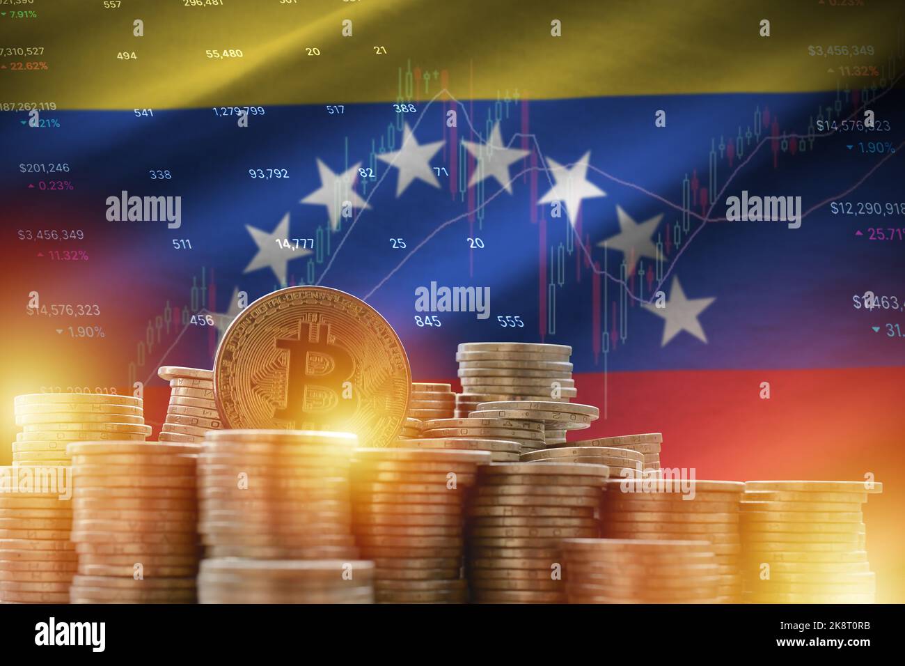 Venezuela flag and big amount of golden bitcoin coins and trading platform chart. Crypto currency concept Stock Photo