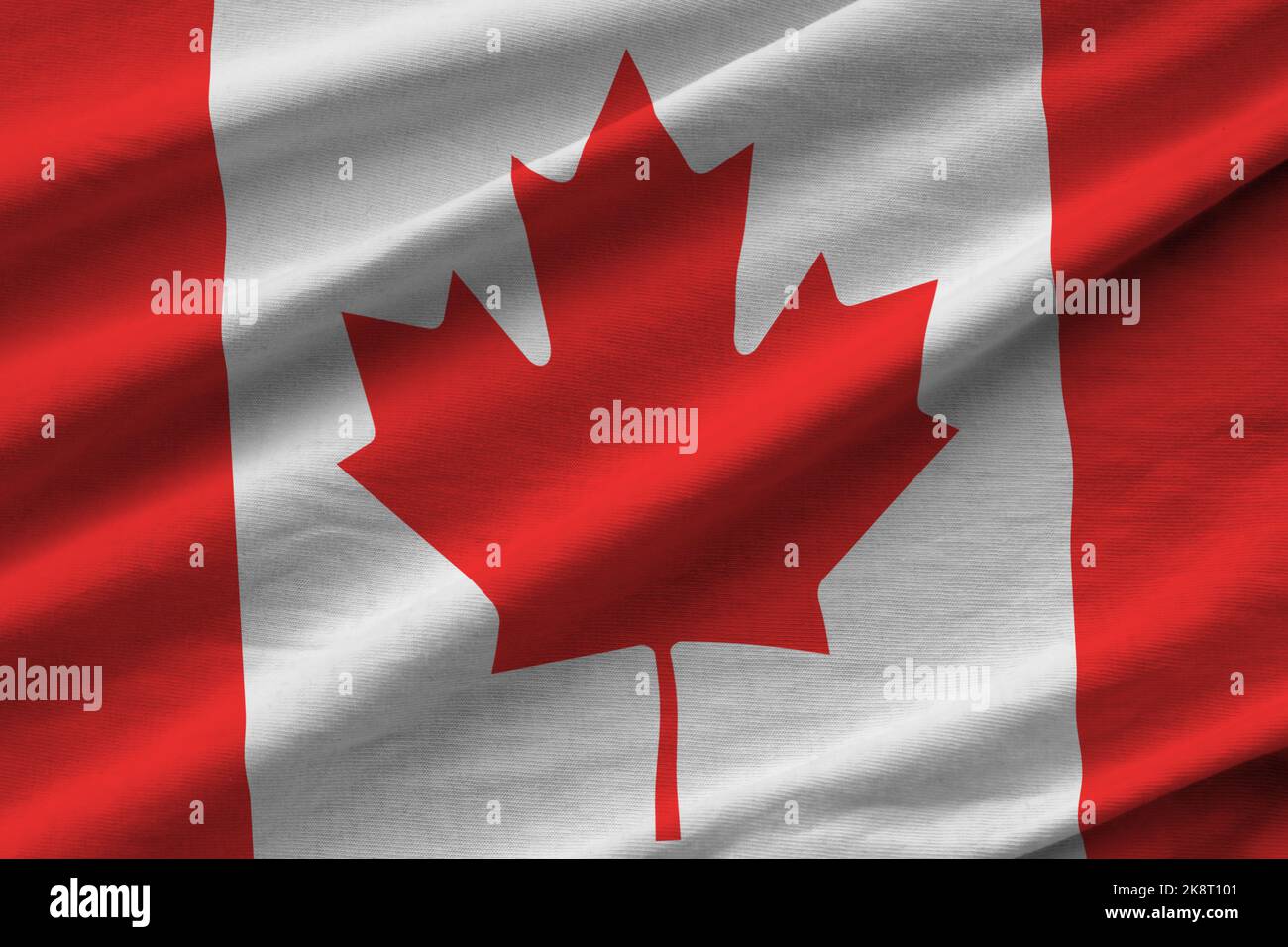 Canada flag with big folds waving close up under the studio light