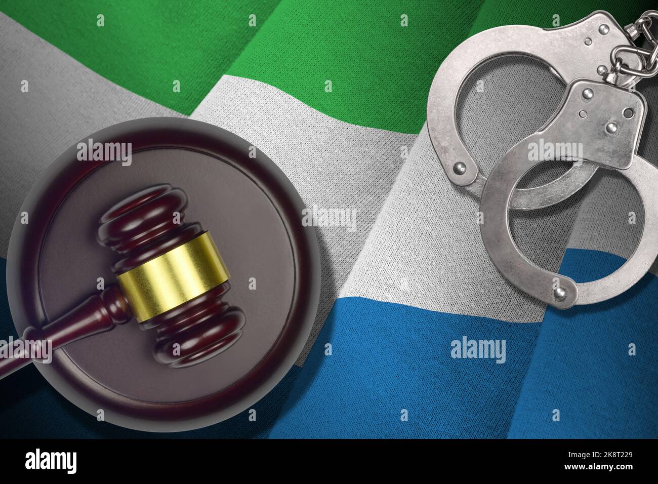 Sierra Leone flag with judge mallet and handcuffs in dark room. Concept of criminal and punishment, background for guilty topics Stock Photo