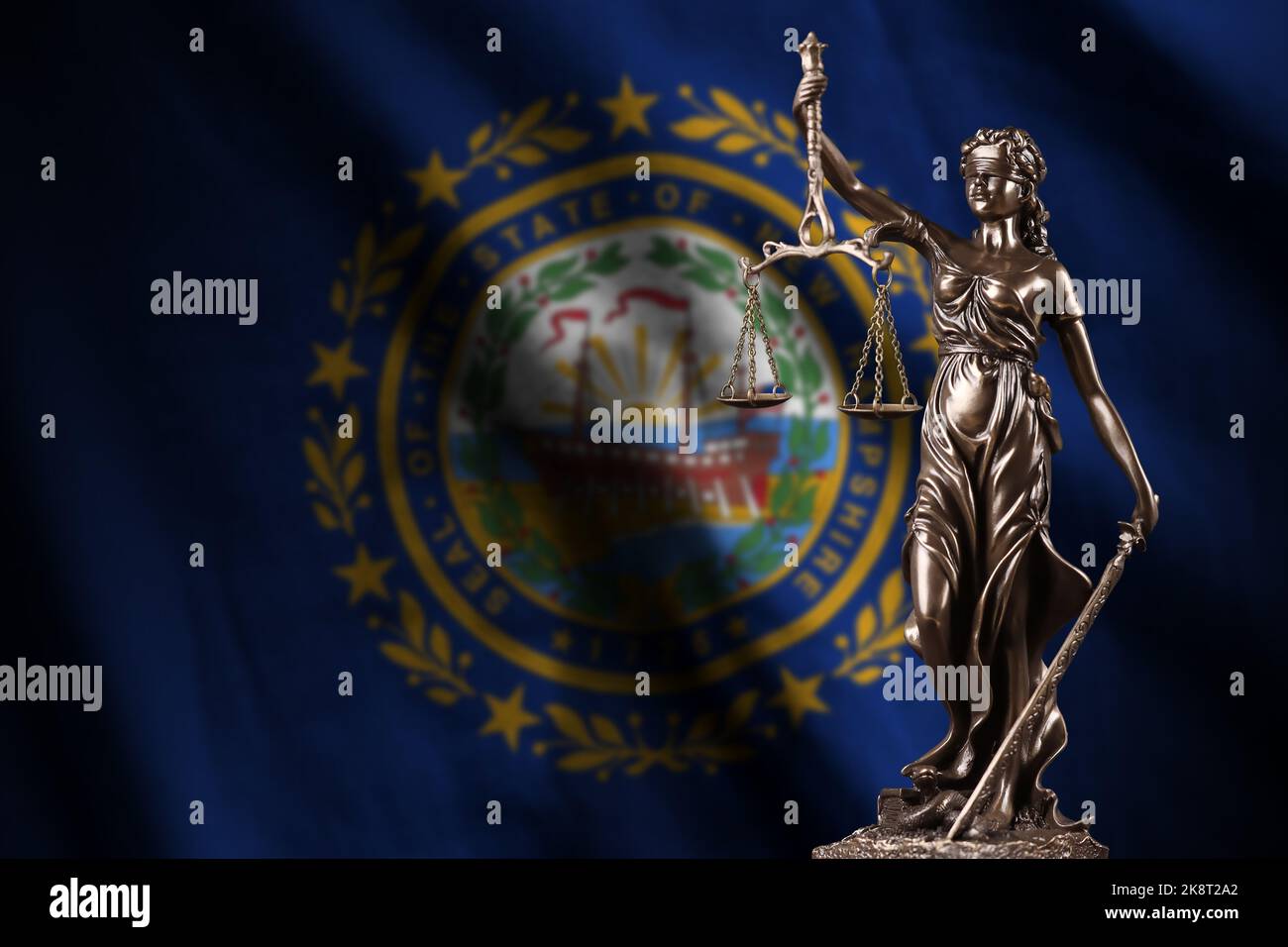 New Hampshire US state flag with statue of lady justice and judicial