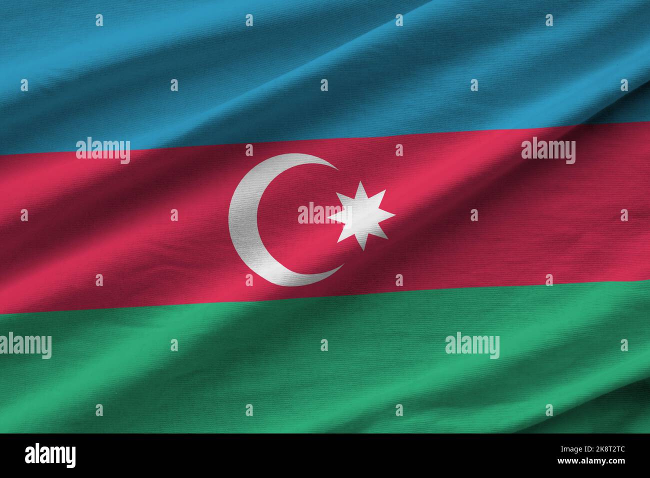 Azerbaijan flag with big folds waving close up under the studio light indoors. The official symbols and colors in fabric banner Stock Photo