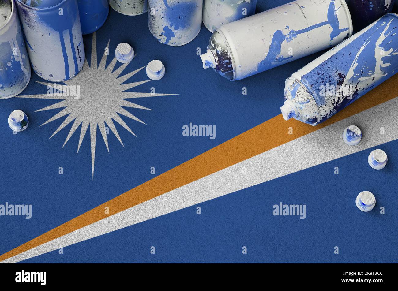 Marshall Islands flag and few used aerosol spray cans for graffiti