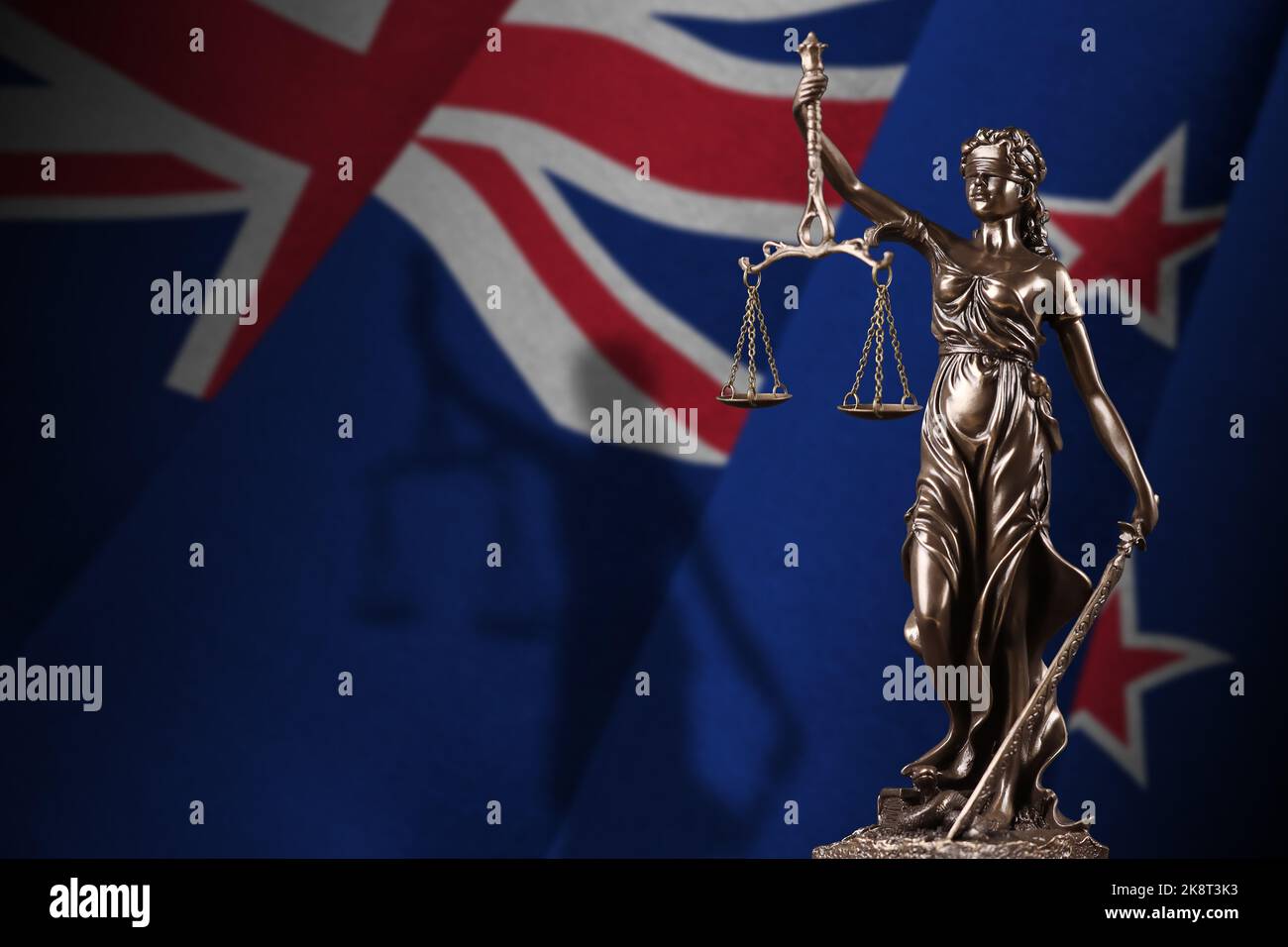 New Zealand flag with statue of lady justice and judicial scales in