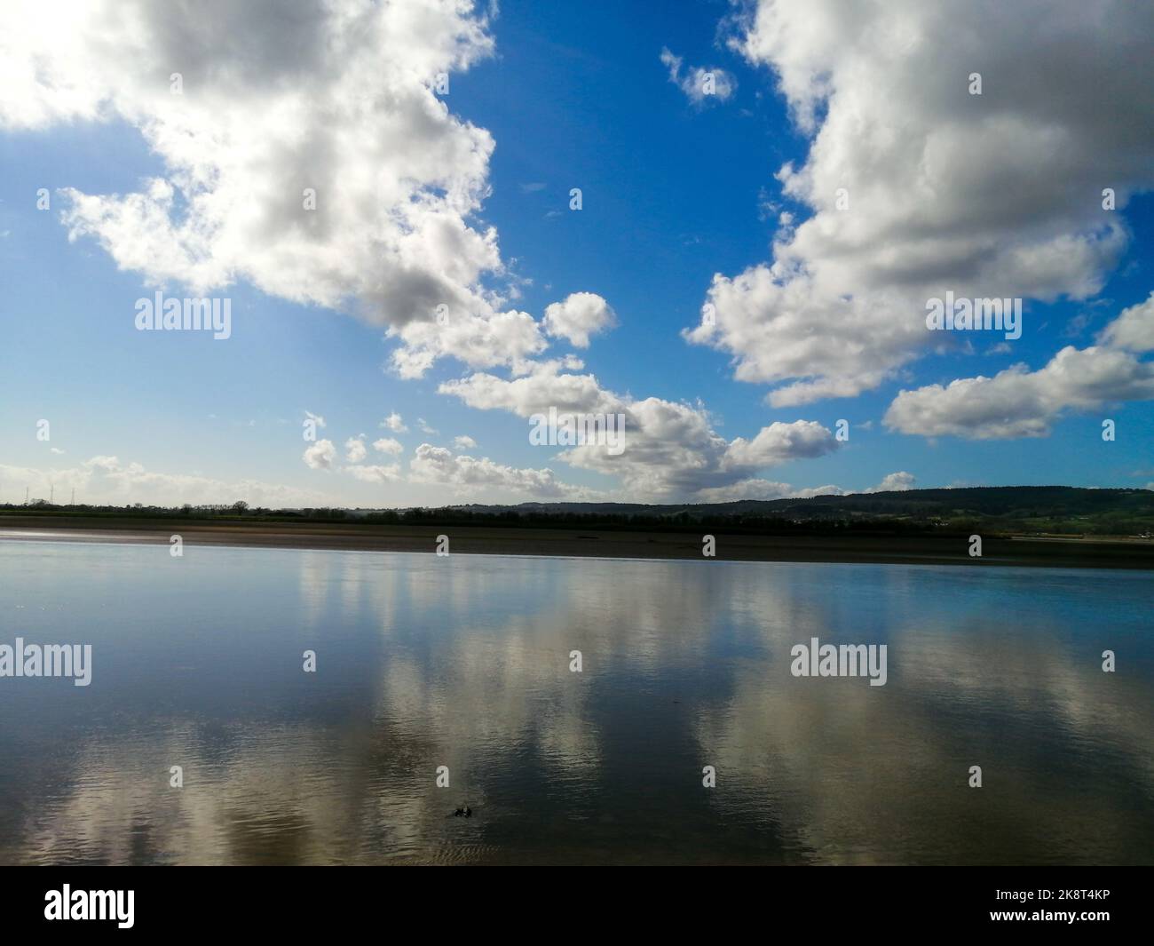 An aerial view of lake surrounded by greenery hills Stock Photo - Alamy
