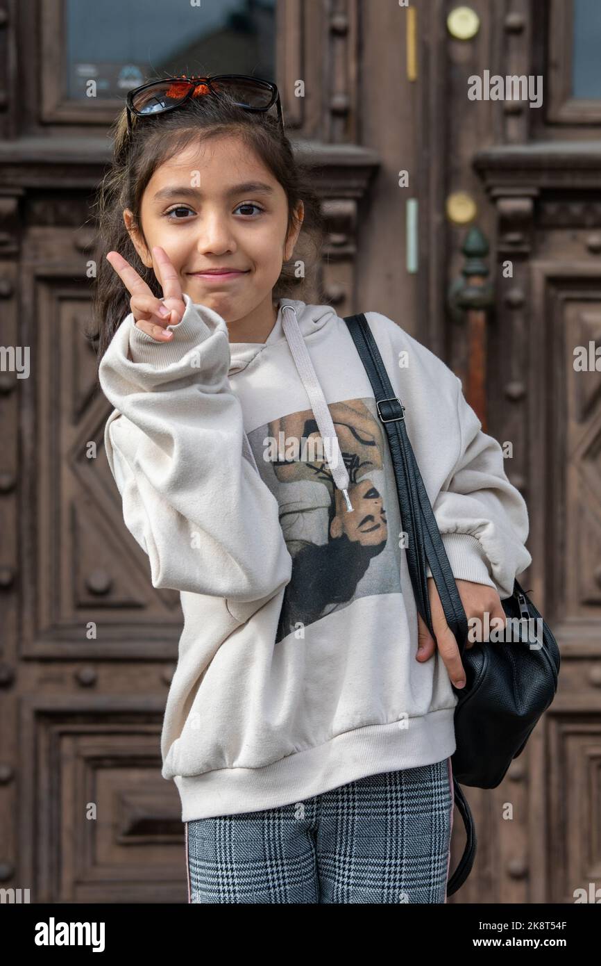 Young girl making V sign or victory hand gesture in Tampere, Finland Stock Photo