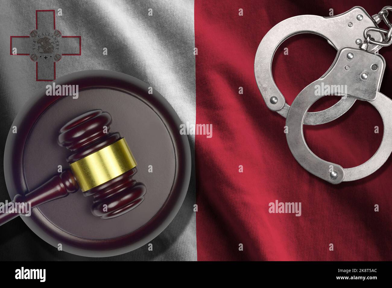 Malta flag with judge mallet and handcuffs in dark room. Concept of