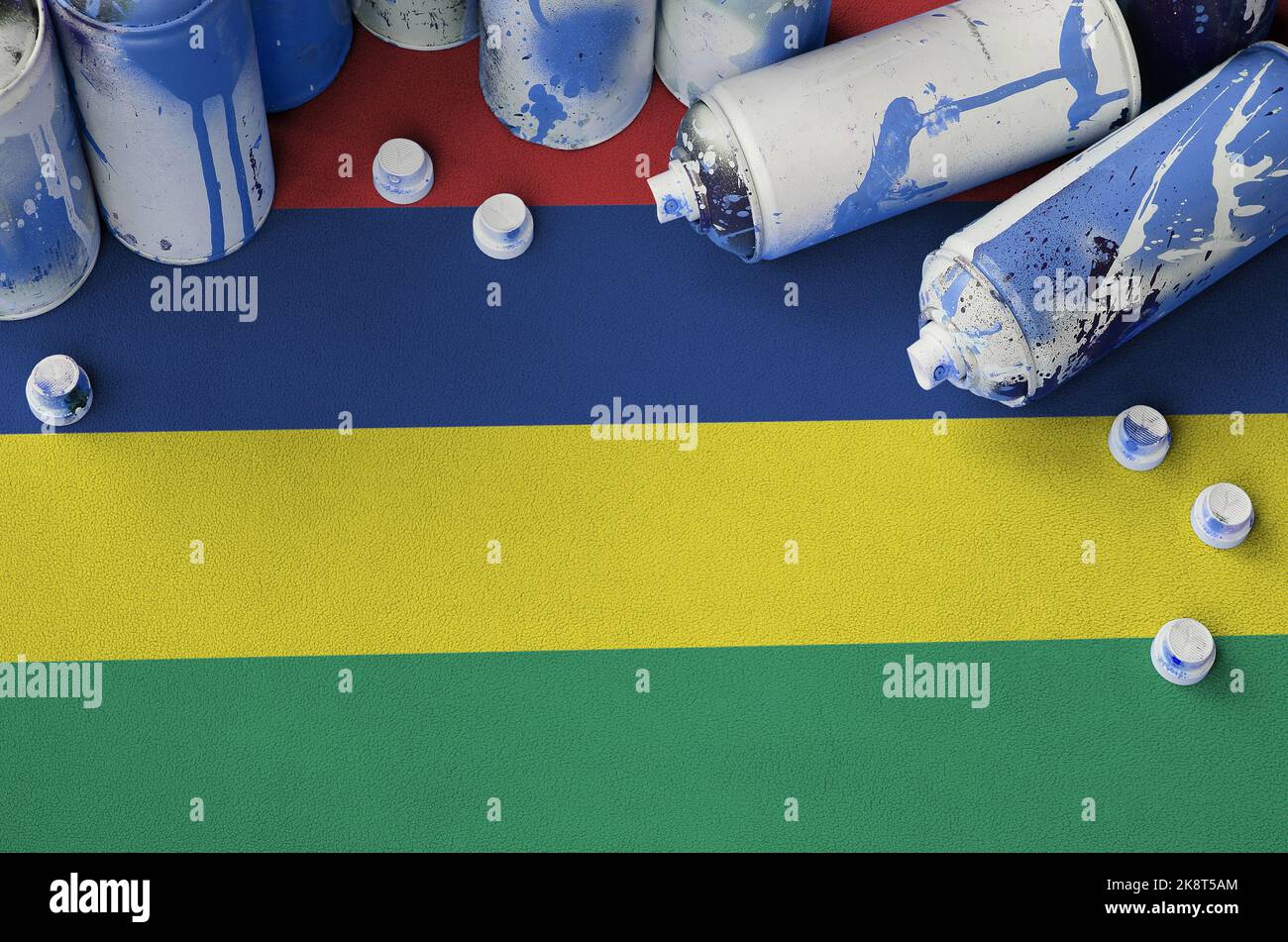 Mauritius flag and few used aerosol spray cans for graffiti painting