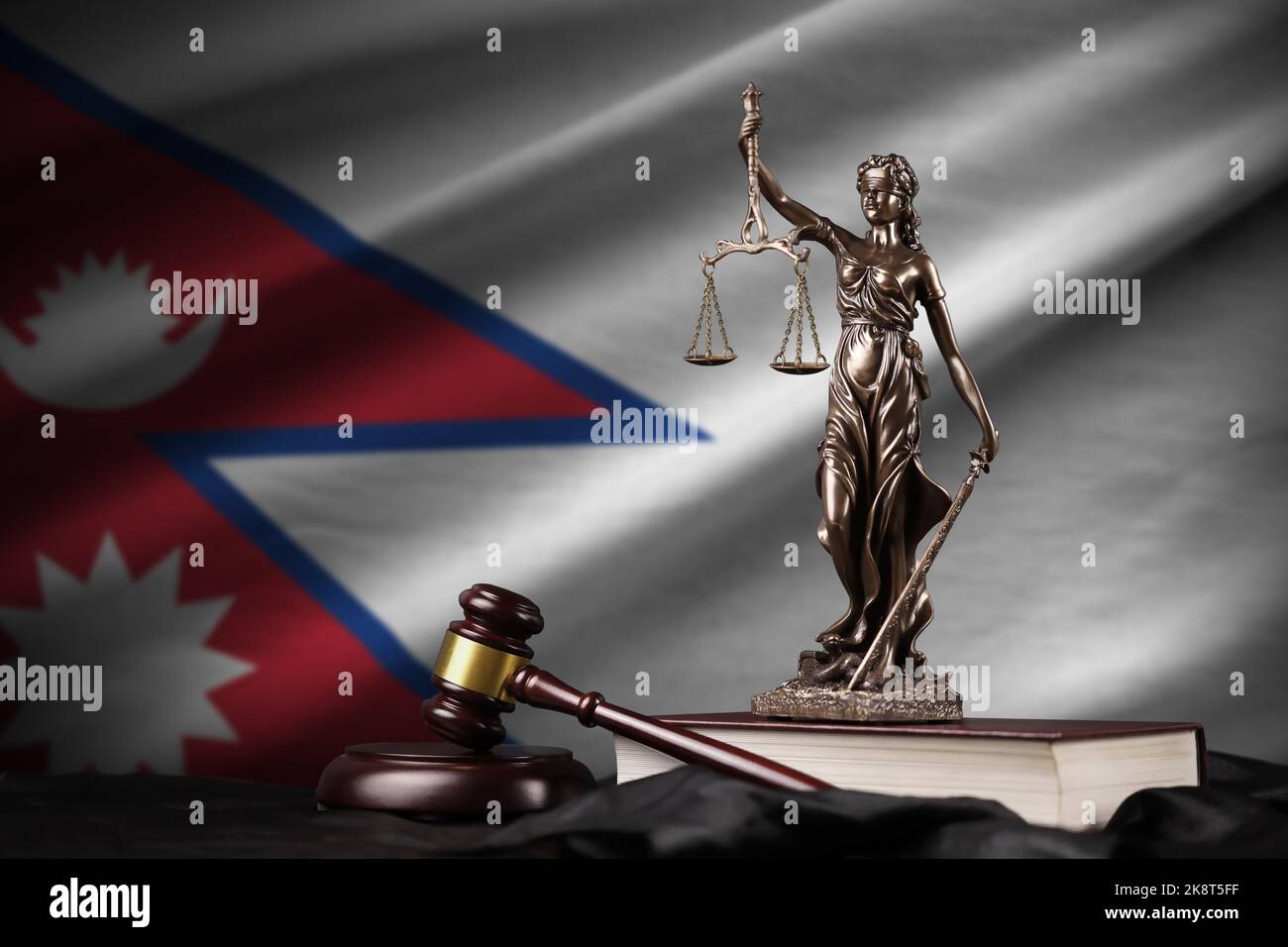 Nepal flag with statue of lady justice, constitution and judge hammer